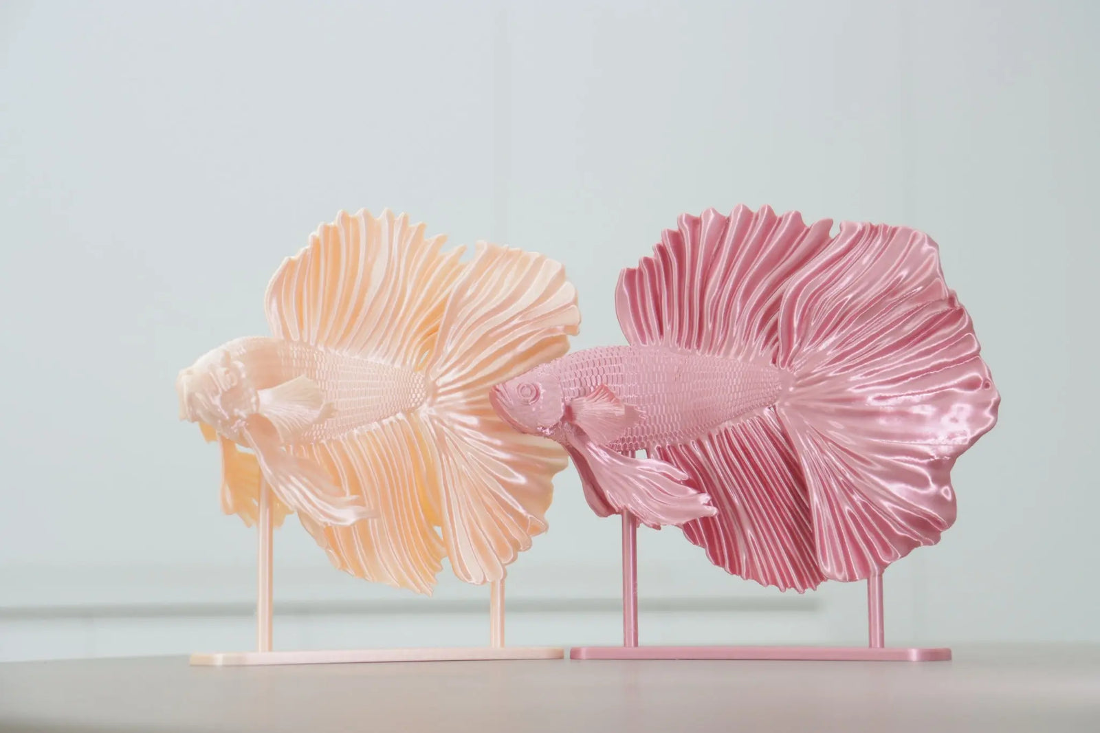 Bring life to your table with these two 3D printed peach and pink betta fish sculptures.